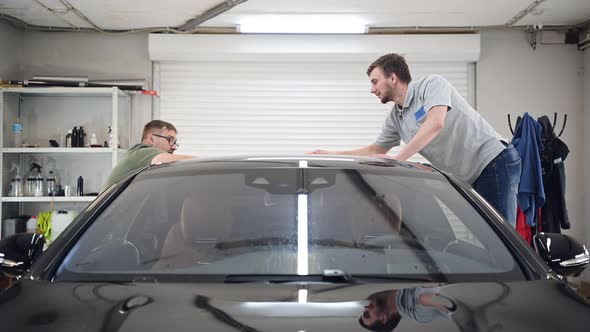 Two Specialist Dries the Car From Moisture, Car Washing at Detailing Service. alt