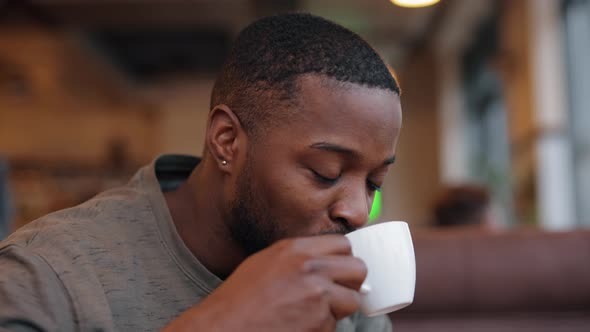 African American Man Drinking Tea Sitting in a Cafe, Slow Motion, Stock ...