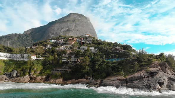 Aerial distancing of the beautiful picturesque cliff rocks of Joatinga beach in Rio de Janeiro with alt