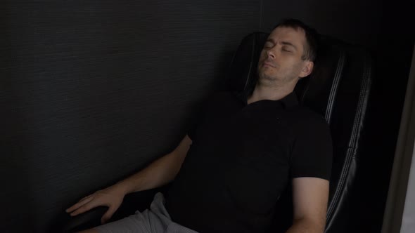 Man Lying Relax and Enjoying in Massage Chair in the Lounge Area in Airport alt