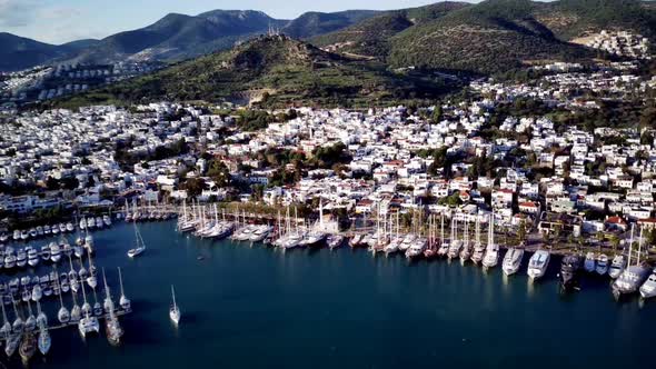 View from drone on full of yachts Bodrum harbour and ancient Kalesi castle in Mugla in Turkey