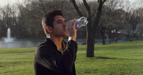 Man Drinking Water From the Bottle Outdoors 12B
