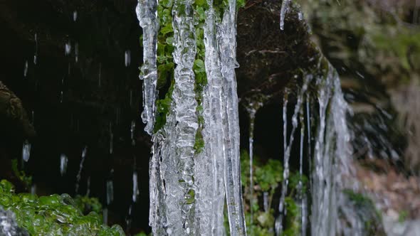 Closeup of Long Beautiful Icicles on Mountain River Waterfall alt