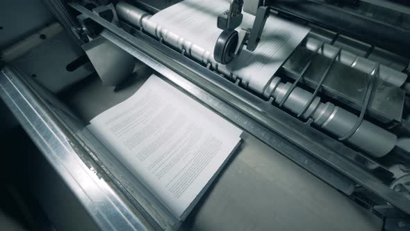 Paper Pages with Text Are Getting Mechanically Issued. Printing Factory Equipment. alt