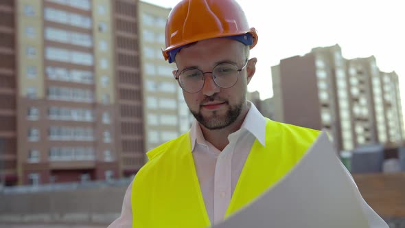 Man Looks in White Paper with House Project alt