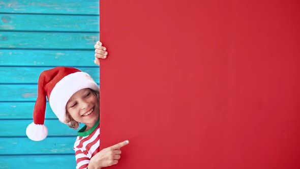 Funny Kid Holding Cardboard Banner Blank. Child Playing At Home. Christmas Holiday Concept