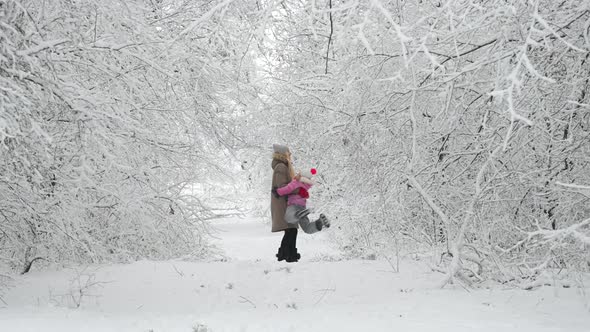Family walks outdoors in cold winter.