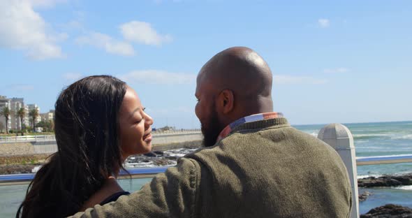 Couple kissing on bench near railing on a sunny day 4k alt