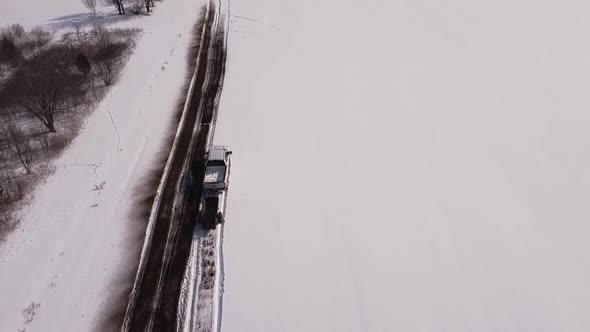 Vast Farmland In Deep Snow With Running Truck Pulling A Manure Spreader In Southeast Michigan. - Aer alt