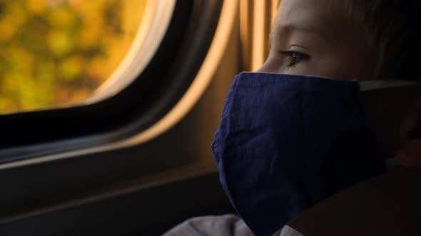 Close Up Child Mask Face Boy Looking Out Window Train Passenger Kid Thinking alt