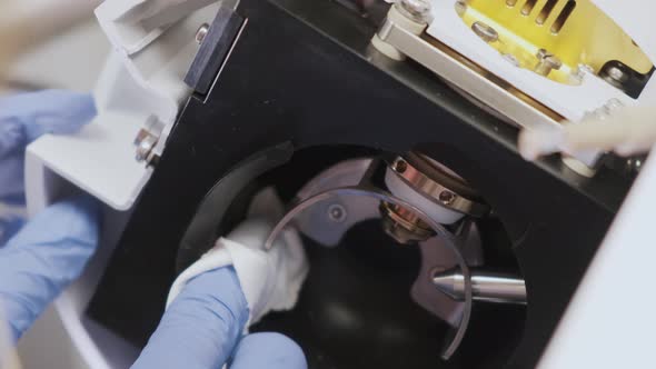 Close Up Scientist Cleaning An Ion Source Of Mass Spectrometer With 