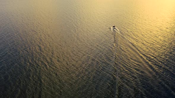 Speeding motor boat in the ocean at the sunset
