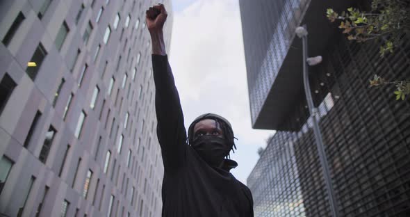Young African American Black Man Rasises His Fists Up in Solidarity Justice