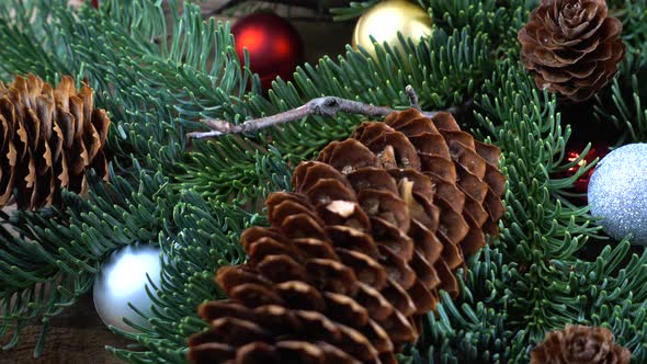 Abies nobilis branch with cones and Christmas balls alt