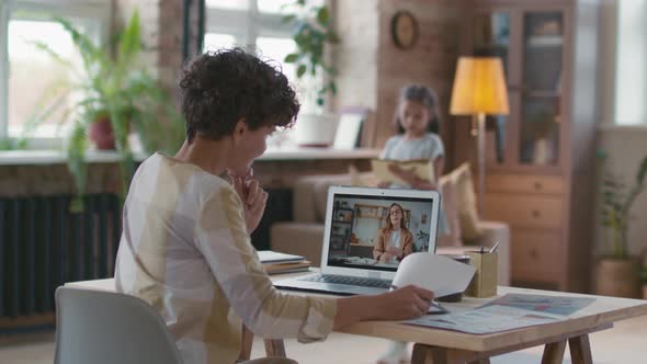 Woman Working from Home and Talking on Video Call alt