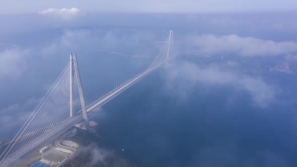 Aerial hyperlapse video of Yavuz Sultan Selim Bridge on a foggy day in Istanbul, Turkey. alt