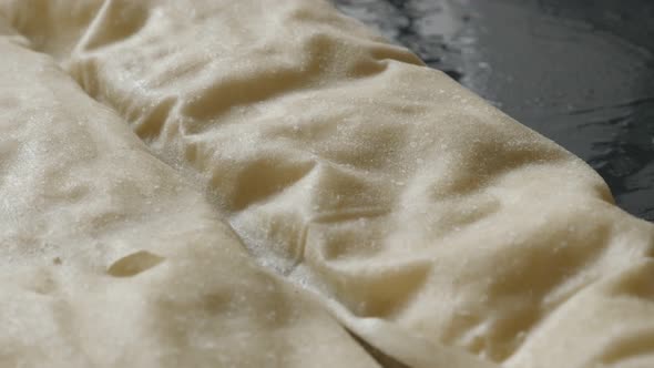 Homemade filo pie with cheese and spinach  rolled tilting 4K 2160p 30fps UHD footage - Slow tilt ove alt