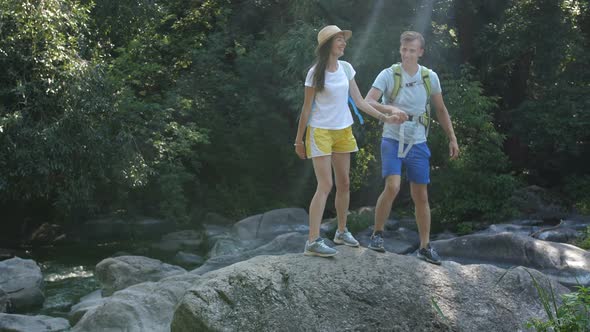 Cheerful Couple of Hikes Enjoying Panaromic View alt