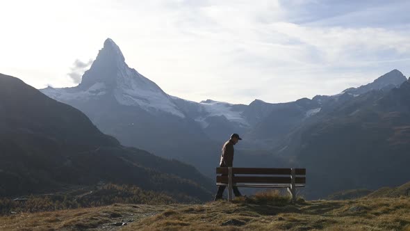 Picturesque View of Matterhorn Peak and Wooden Bench in Swiss Alps