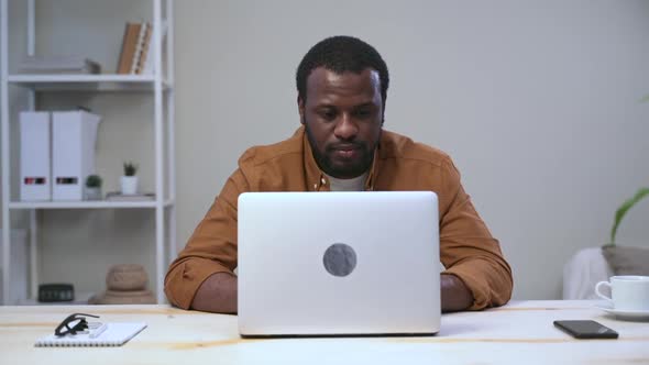 African Man After Laptop Looks to Side to Relax From Work Fatigue Spbas alt