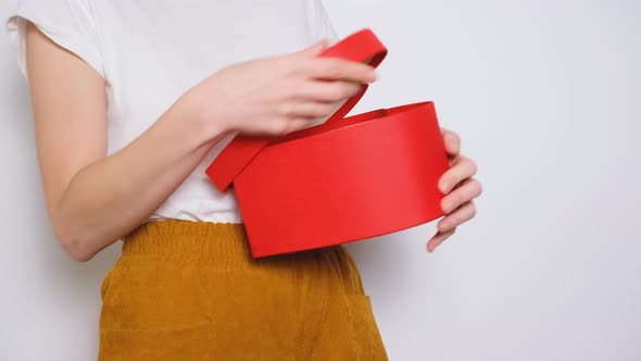 Woman Open Big Red Box in Shape of a Heart and Very Happy About Her Gift alt