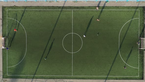Top View of a Sports Football Field with Players Playing Football alt