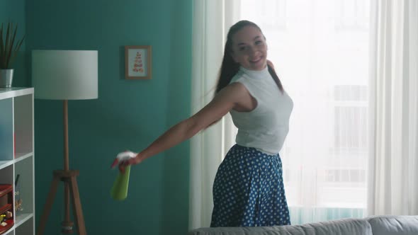 Energetic Woman Is Busy with Cleaning