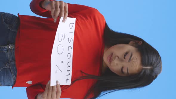 Young Woman Holding Discount Sign alt