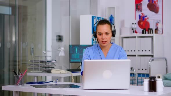 Assistant Offering Medical Services Using Headphone Answering Calls alt