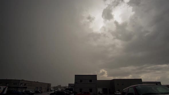 Time lapse of rain storm rolling through industrial area alt