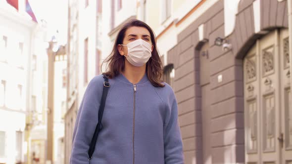 Woman Wearing Medical Mask Walking in City alt
