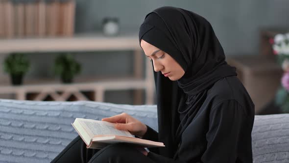Saudi Woman Read Holy Muslim Book on Comfortable Sofa at Cosiness Home alt