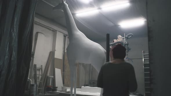 Diverse Sculptors Entering Grungy Workshop alt