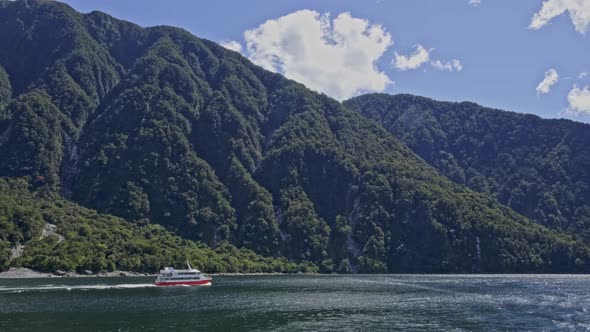Luxury Cruise Ship Travelling At Milford Sound (Piopiotahi) In Fiordland, New Zealand. - wide shot alt