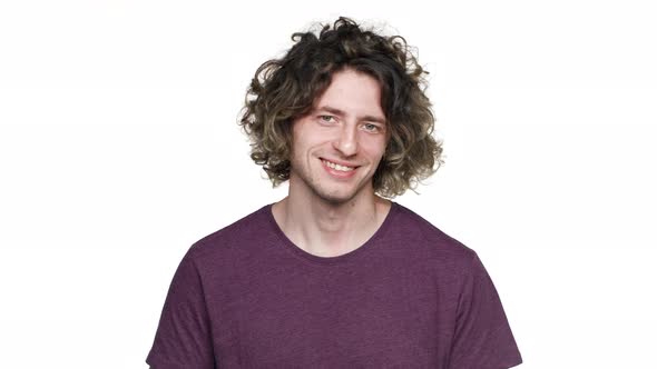 Portrait of Positive Unshaved Man in Casual Tshirt Smiling and Showing Ok Symbol with Fingers alt