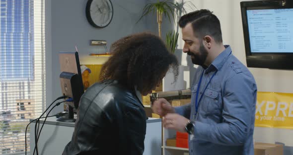 Woman Mailing a Package in a Delivery Center alt