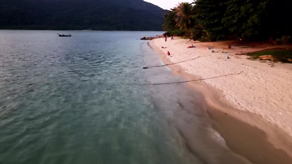 Aerial Low Flying Along Sunset Beach At Koh Lipe. Dolly Forward alt