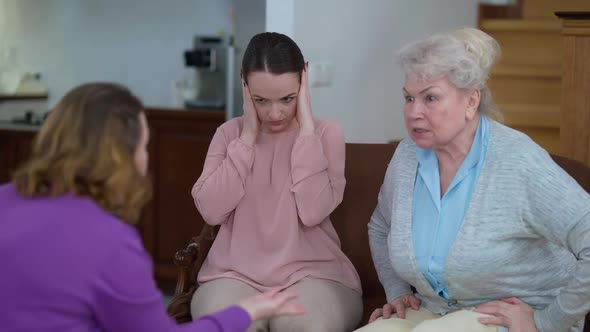 Portrait of Depressed Frustrated Caucasian Young Woman Closing Ears with Hands As Mother and alt