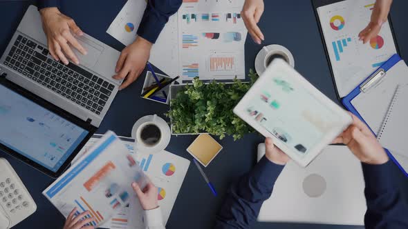 Top View of Businessman Showing Company Management Statistics Using Digital Tablet alt
