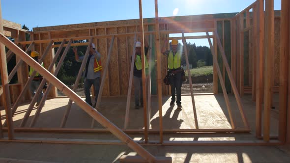 Group of construction workers standing up wall alt