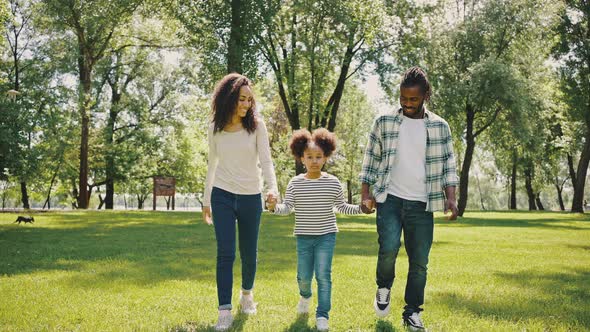 Family Walking in Park alt