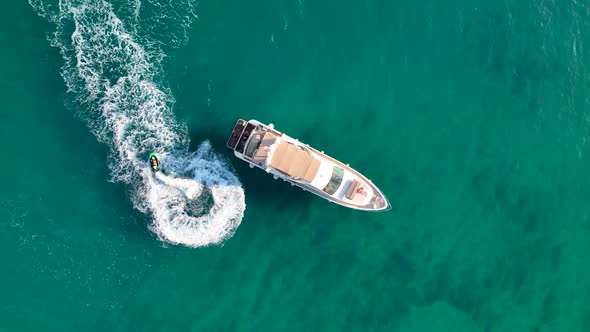 Jet Ski Rides Around the Yacht Aerial View alt