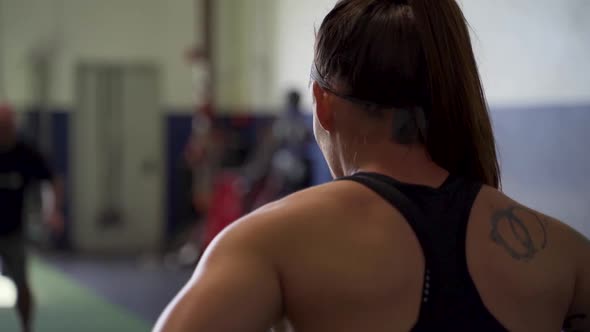 Camera circling around female athlete lisening to trainer alt