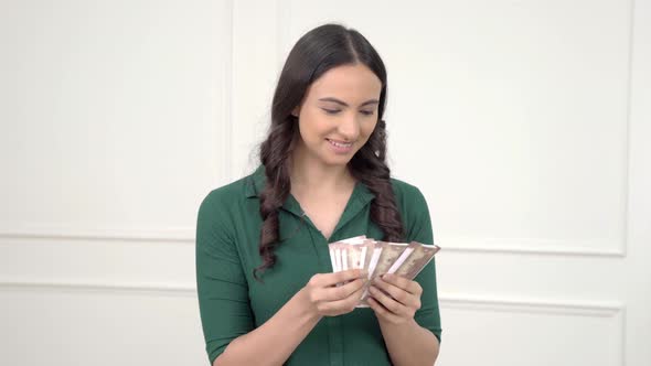 Indian woman counting money alt