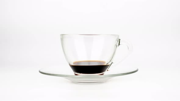 Stop motion of coffee pouring in cup isolated on white background