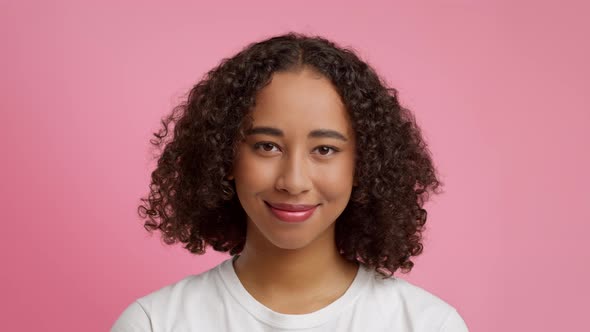 Black Millennial Woman Winking Eye To Camera Over Pink Background alt