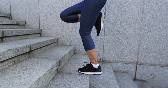 Fitness sports woman running up stairs in city alt