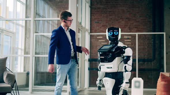Modern Robot and a Businessman are Having a Conversation alt