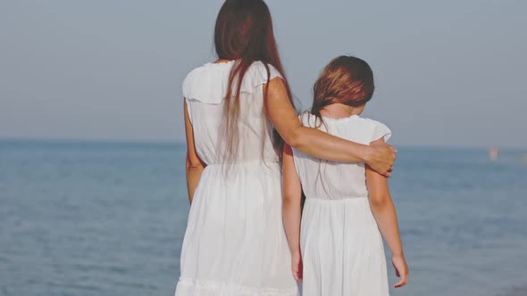 Mom and Daughter Walking By the Sea alt