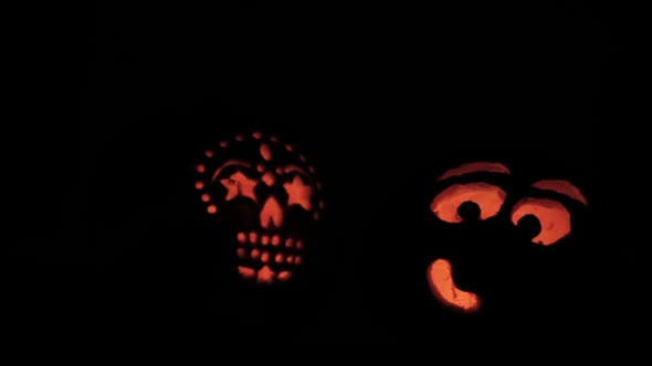 Glowing in the dark spooky Jack-o-lanterns carved from real pumpkins. alt